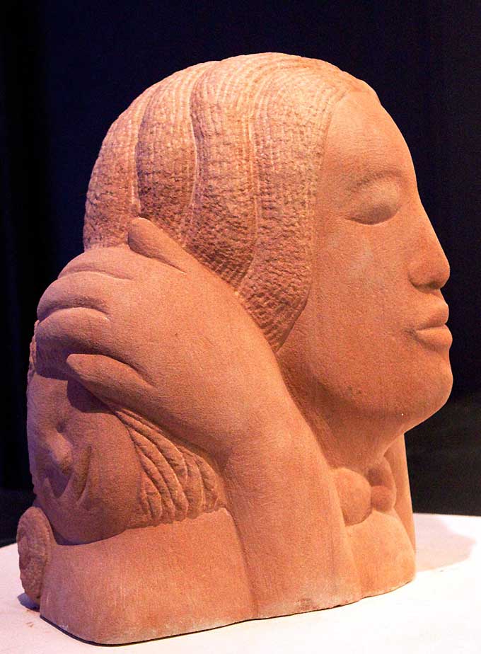 Terracotta stone sculpture of a head in profile, warm earthy tone, calm sculptural mood